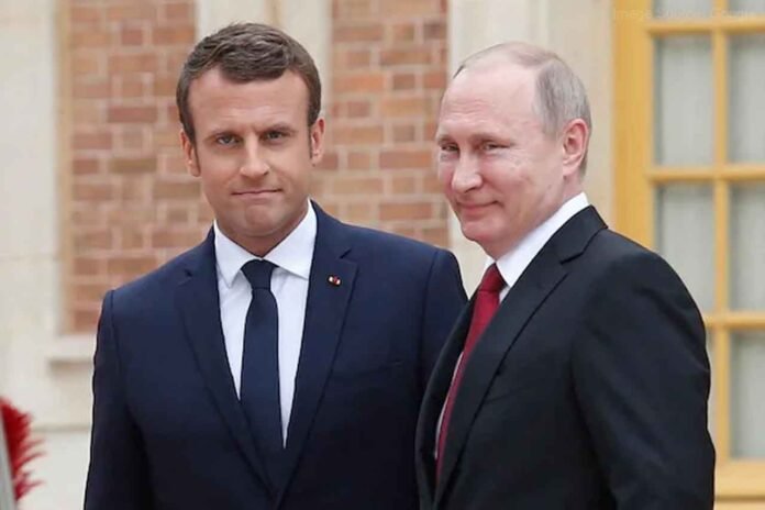 France President Emmanuel Macron talks to Putin